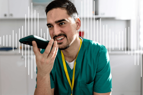Green man in scrubs dictating mobile